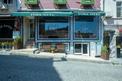 a store front with a bench in front of a street at Fors Hotel in Istanbul