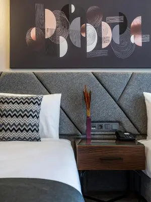 a hotel room with a bed and a nightstand with a table with a bed at Hotel Bristol in Istanbul