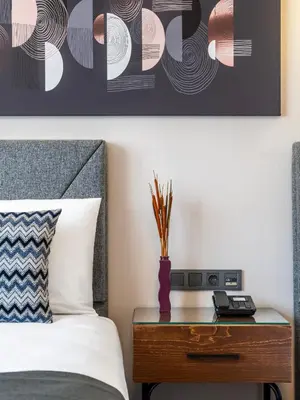 a bedroom with a bed and a table with a vase at Hotel Bristol in Istanbul