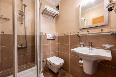 a bathroom with a toilet and a sink and a shower at Hotel Bristol in Istanbul