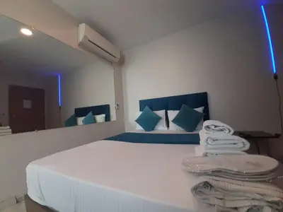 a bedroom with a large white bed with blue pillows at 216 Turkuaz Suit in Istanbul