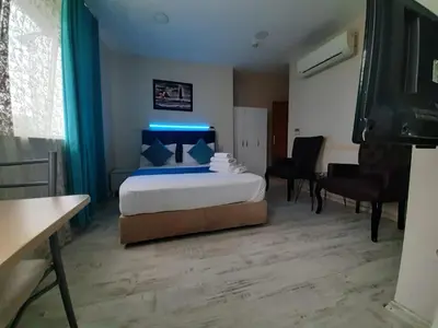 a bedroom with a bed with a blue light on it at 216 Turkuaz Suit in Istanbul