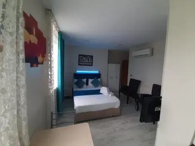 a bedroom with a bed and a table and chairs at 216 Turkuaz Suit in Istanbul