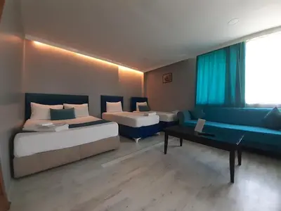 a hotel room with two beds and a couch at 216 Turkuaz Suit in Istanbul
