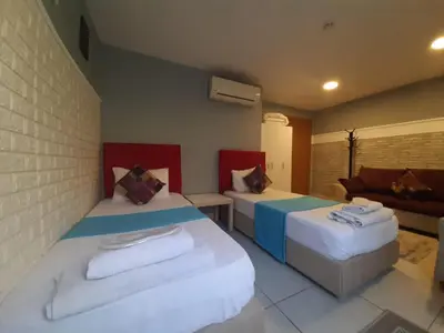 a bedroom with two beds and a couch at 216 Turkuaz Suit in Istanbul