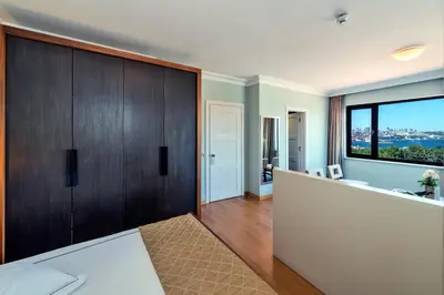 a bedroom with a large wooden door and a large window at Agora Life Hotel - Special Class in Istanbul