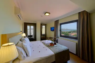 a hotel room with a bed with a large window at Agora Life Hotel - Special Class in Istanbul
