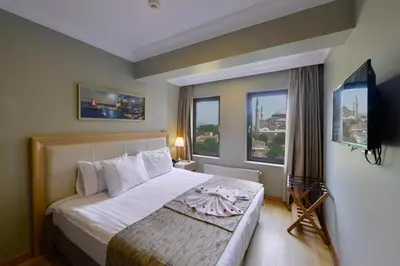 a bedroom with a large bed and a large window at Agora Life Hotel - Special Class in Istanbul