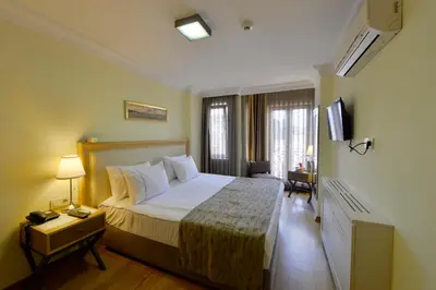 a hotel room with a bed and a television at Agora Life Hotel - Special Class in Istanbul