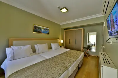 a bedroom with a large bed and a flat screen tv at Agora Life Hotel - Special Class in Istanbul