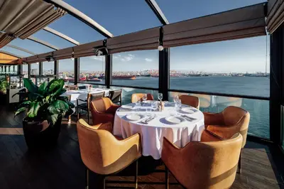 a restaurant with tables and chairs and a view of the water at Holiday Inn Istanbul - Tuzla Bay by IHG in Istanbul