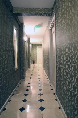 a hallway with a tiled floor in a building at Kuzen Otel in Istanbul