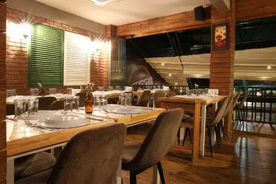 a dining room with wooden tables and chairs at Kuzen Otel in Istanbul