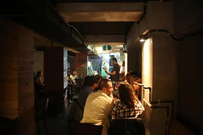a group of people sitting at a restaurant at Kuzen Otel in Istanbul