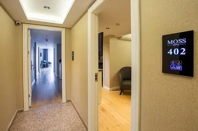 a hallway with aosis sign on the wall of a room at Moss Suites Hotel in Istanbul