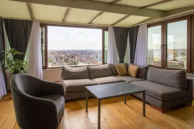 a living room with a couch and a table at Moss Suites Hotel in Istanbul