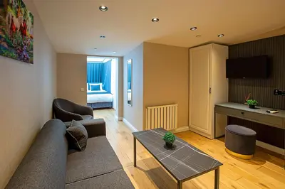 a living room with a couch and a table at Moss Suites Hotel in Istanbul
