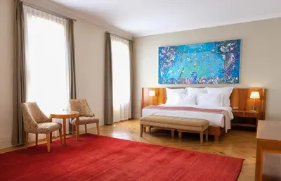 a bedroom with a bed and a painting on the wall at Tomtom Suites in Istanbul