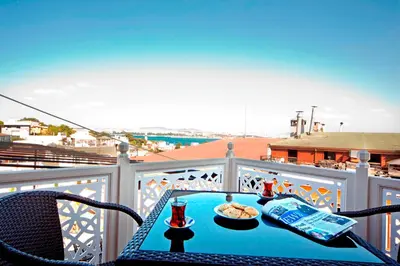 a table with a plate of food on a balcony at Apart Hotel Hippodrome in Istanbul