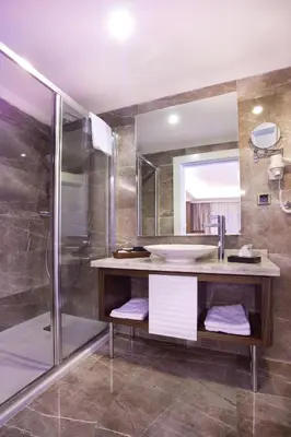 a bathroom with a sink and a shower at Mirilayon Hotel - Old Town in Istanbul