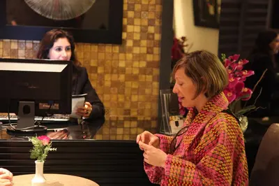 a woman sitting at a counter in a coffee shop at Mirilayon Hotel - Old Town in Istanbul