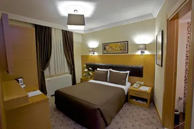 a hotel room with a bed and a desk at Mirilayon Hotel - Old Town in Istanbul