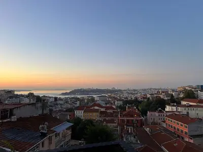 a view of a city skyline at sunset at Louis Rooms in Istanbul