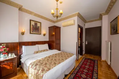 a bedroom with a bed and a rug at Osmanhan Hotel in Istanbul