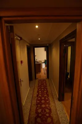 an empty hallway with a rug on the floor of a room at Tashkonak Studio Suites in Istanbul