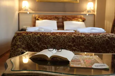 a table with a book and glasses on top of a bed at Tashkonak Studio Suites in Istanbul