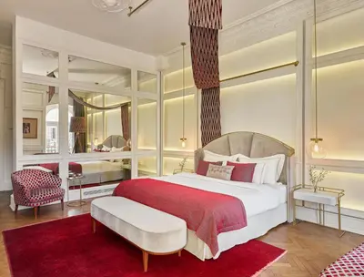 a bedroom with a large bed and a red rug at Mr Cas Hotels Taksim - Special Category in Istanbul