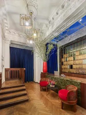 a lobby with a staircase and red chairs at Mr Cas Hotels Taksim - Special Category in Istanbul