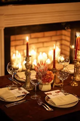 a table with candles and wine glasses on a table with a fireplace at Mr Cas Hotels Taksim - Special Category in Istanbul