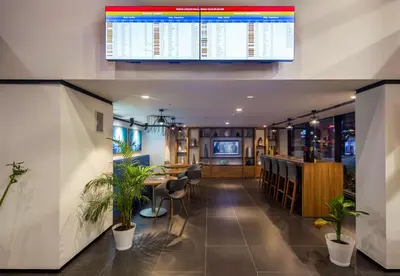 a restaurant with a bar with plants in a room at Hampton by Hilton Istanbul Kurtkoy in Istanbul