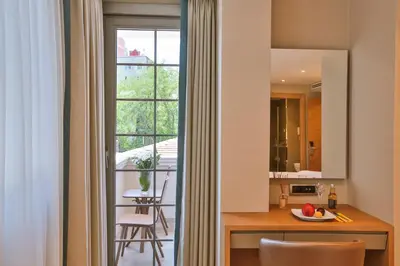 a kitchen and dining room with a table and a window at Ada Suites Nisantasi in Istanbul