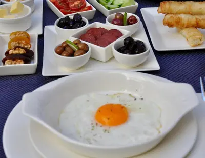 a plate of food with an egg on a table at Ada Suites Nisantasi in Istanbul