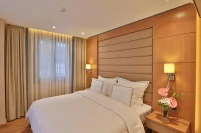 a bedroom with a large white bed and a window at Ada Suites Nisantasi in Istanbul