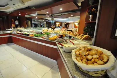 a buffet line with a lot of food in a restaurant at Hotel Buyuk Sahinler in Istanbul
