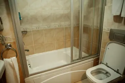 a bathroom with a shower and a toilet at Yuksel Hotel in Istanbul