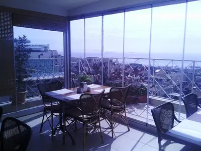 a dining room with a table and chairs on a balcony at Hotel Linda in Istanbul