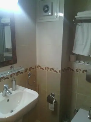a bathroom with a sink and a toilet and a mirror at Hotel Linda in Istanbul