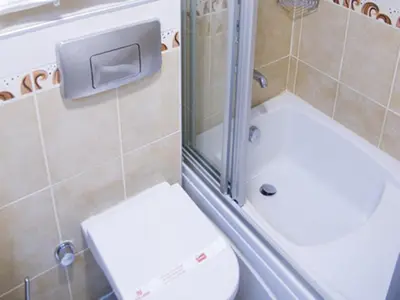 a small bathroom with a toilet and a shower at Hotel Linda in Istanbul