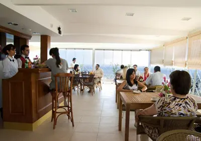 a group of people sitting at tables in a restaurant at Hotel Linda in Istanbul