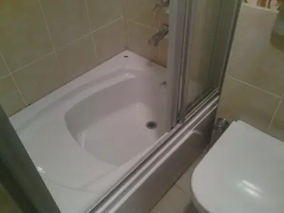 a white bath tub in a bathroom with a toilet at Hotel Linda in Istanbul