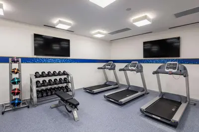 a gym with treadmills and exercise bikes in a room at Hampton by Hilton Istanbul Zeytinburnu in Istanbul