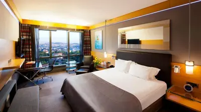 a hotel room with a bed and a desk at Point Hotel Barbaros in Istanbul