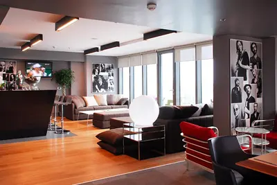 a living room with a couch and a table and chairs at Point Hotel Barbaros in Istanbul
