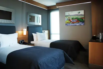 a hotel room with two beds and a window at Point Hotel Barbaros in Istanbul