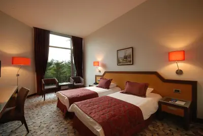 a hotel room with two beds and a window at Hotel Hegsagone Marine Asia in Gebze
