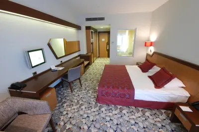 a hotel room with a bed and a desk at Hotel Hegsagone Marine Asia in Gebze